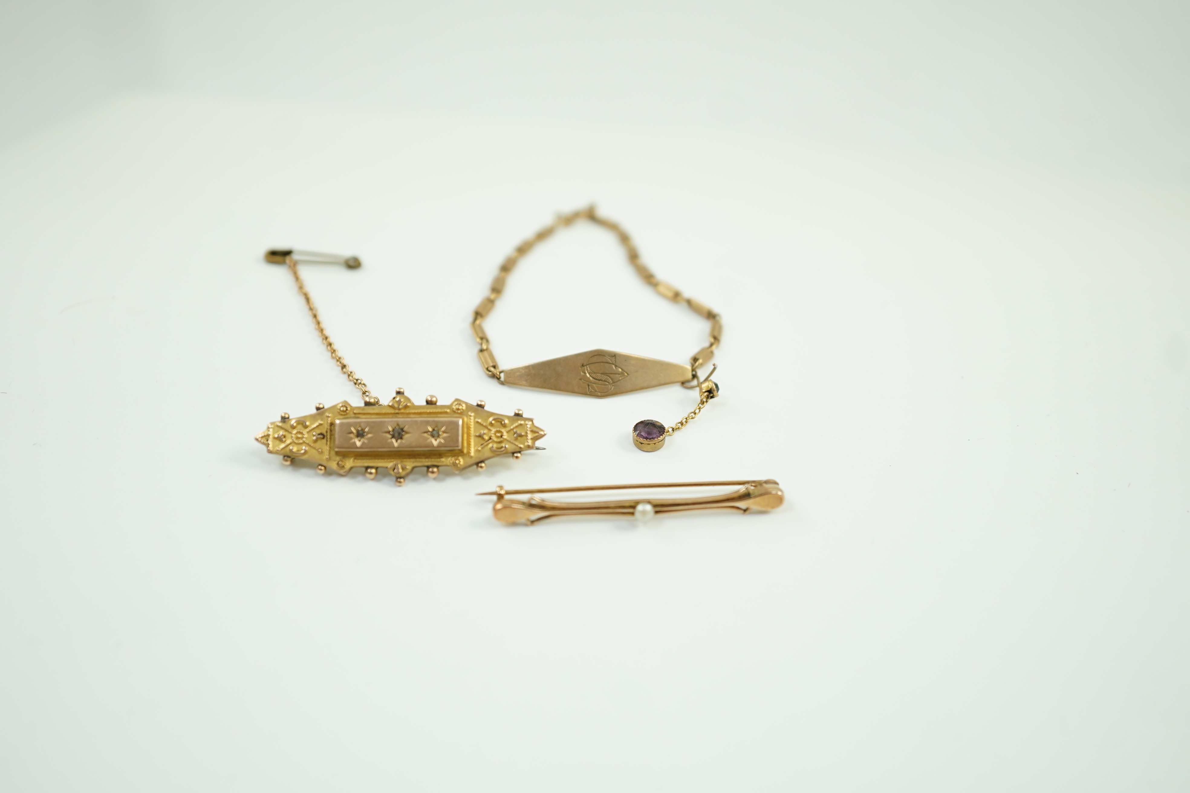 Two early 20th century yellow metal brooches including 9ct and diamond chip set and a seed pearl set bar brooch by Murrle Bennett & Co?, together with a 9ct identity bracelet, gross weight 10.6 grams.